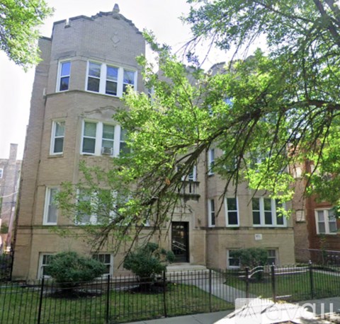 A large building with a black fence in front.
