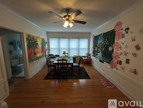 A dining room with a table set for four.