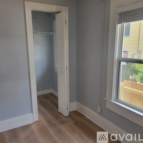 A room with a white door and a window.