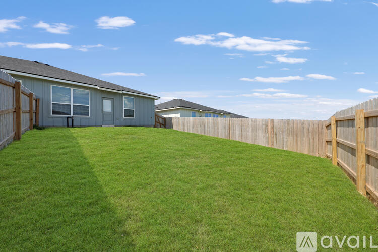 A house with a fence and a grassy yard.