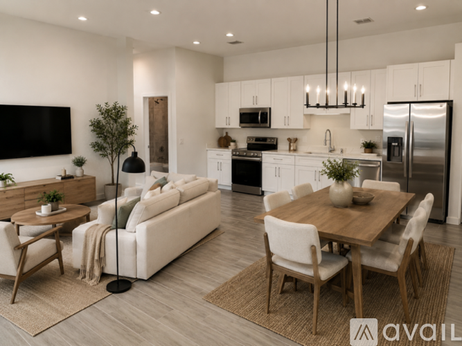 A modern kitchen with white cabinets and stainless steel appliances.