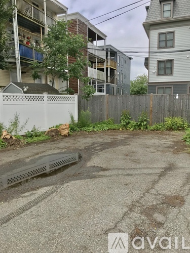 A parking lot with apartment buildings in the background.