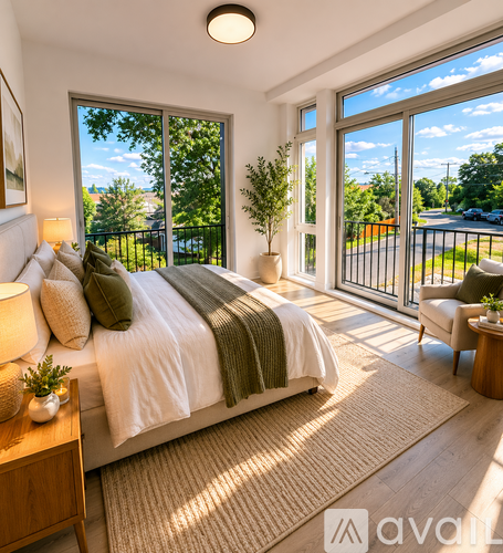 A bedroom with a large bed and a view of the outside through the sliding glass doors.
