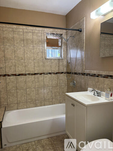 A bathroom with a white bathtub and a sink.