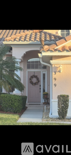 A house with a brown door and a wreath on it.