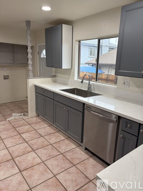 A kitchen with a sink and a window.