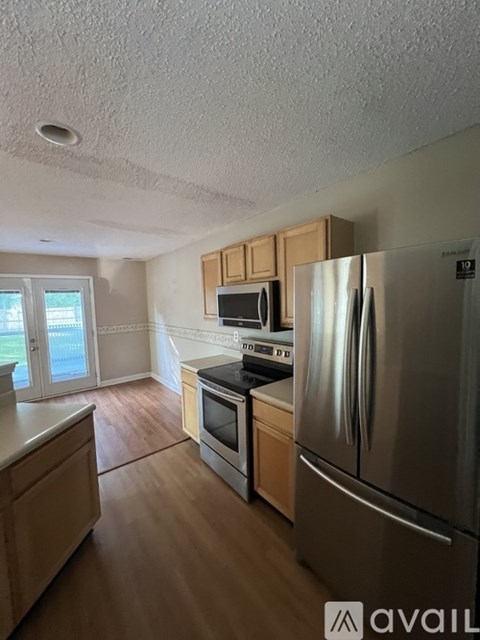 A kitchen with wooden cabinets and stainless steel appliances.