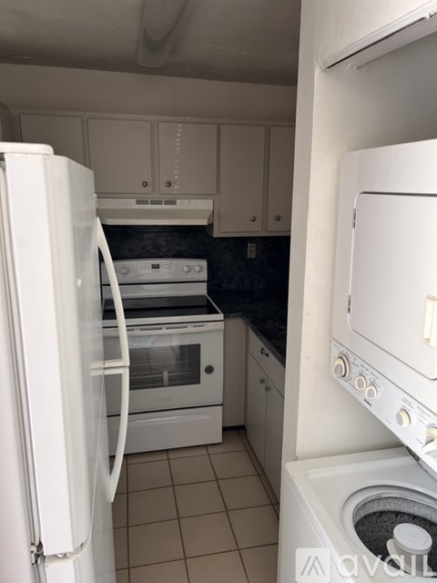 A white refrigerator is open in a kitchen.