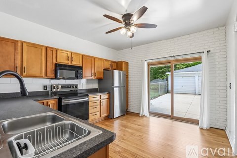 A kitchen with wooden cabinets and a stainless steel sink.