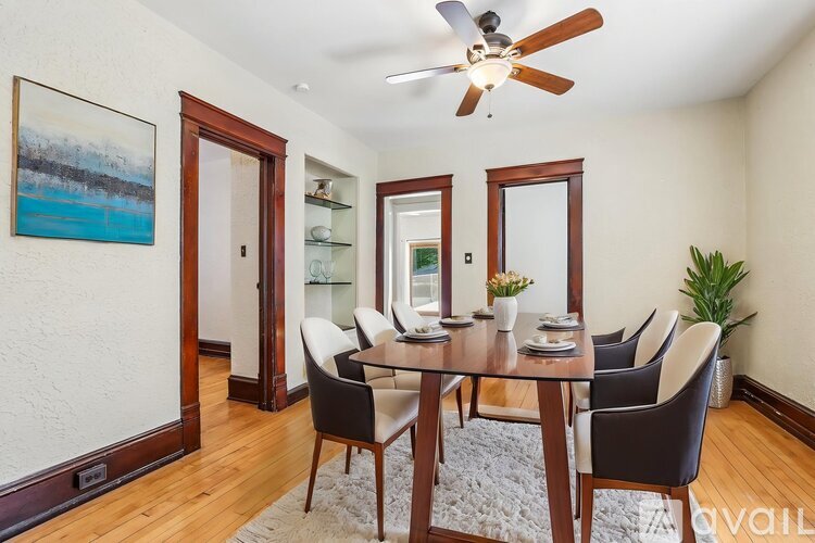 A dining room with a glass table and chairs.