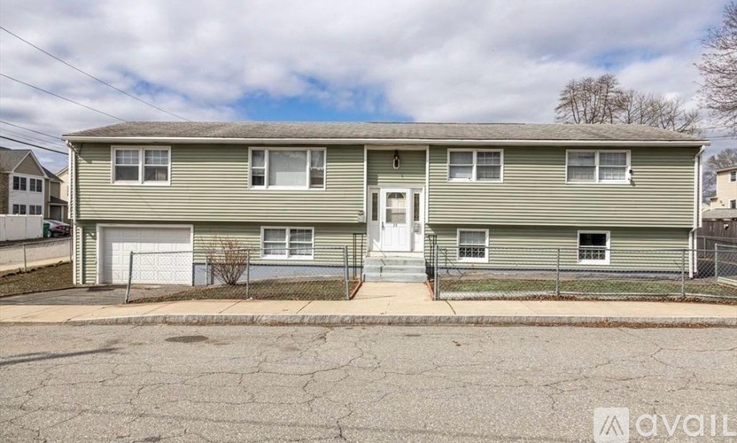 A two-story residential building with a garage on the first floor.