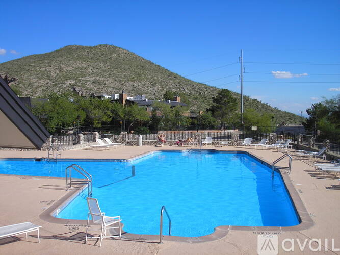 A large swimming pool with a mountain in the background.