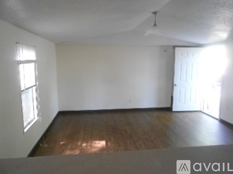 A room with wooden floors and white walls.