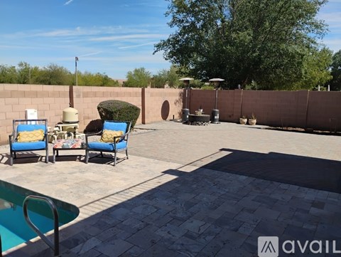 A patio with a pool table and chairs.