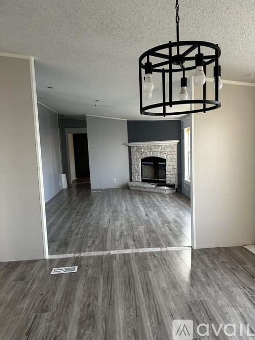 A room with a fireplace and a chandelier.