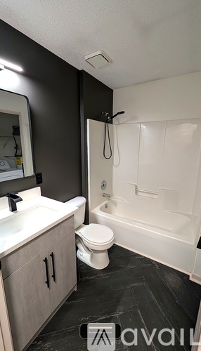 A bathroom with a toilet, sink, and bathtub.