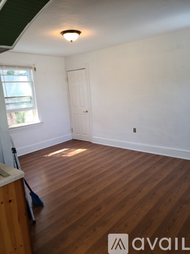 A room with wooden floors and white walls.
