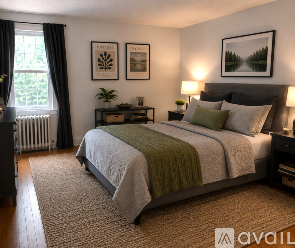 A bedroom with a large bed and a green blanket.