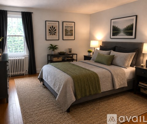 A bedroom with a large bed and a green blanket.