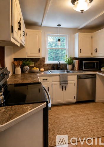 A kitchen with granite countertops and white cabinets.
