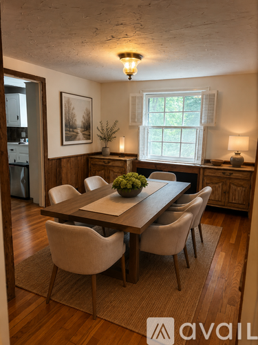 A dining room with a wooden table and chairs.