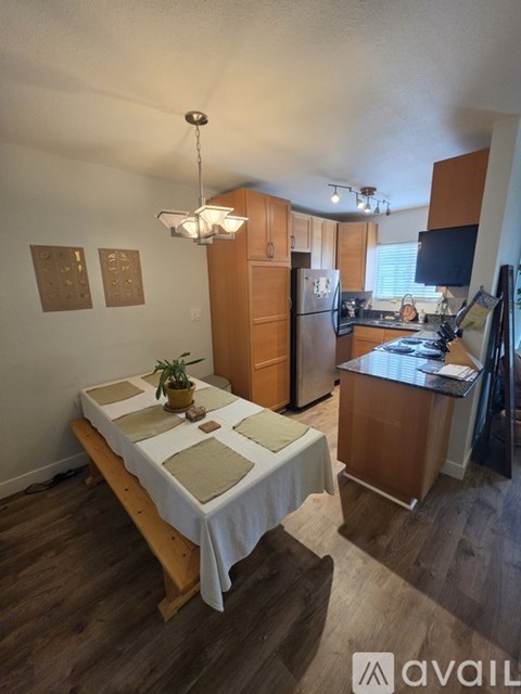 A kitchen with a table and chairs in the middle of the room.