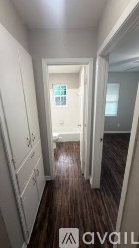 A hallway with a sign that says "available" on the floor.