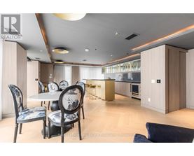 A modern dining room with a table set for four.