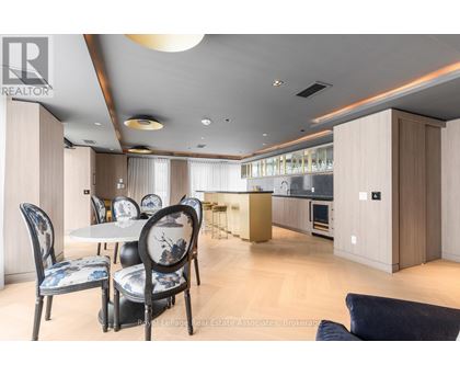 A modern dining room with a table set for four.