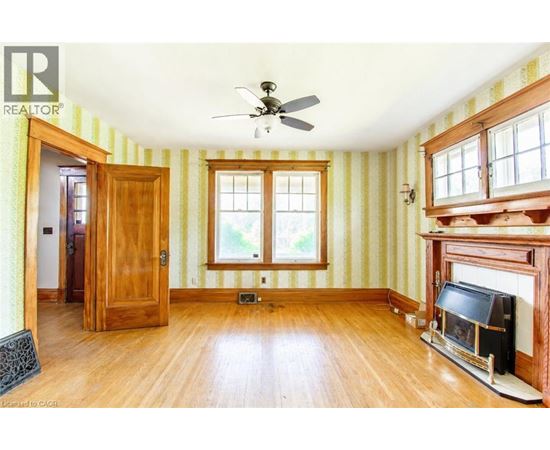 A room with a fireplace and a ceiling fan.