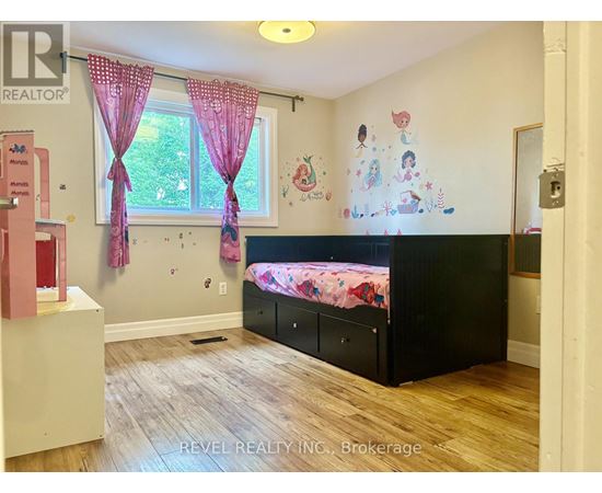 A child's bedroom with a pink and black theme.