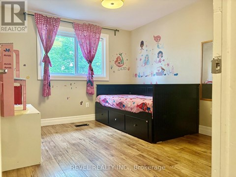 A child's bedroom with a pink and black theme.