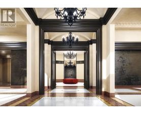 A hallway with a chandelier and a red bench.