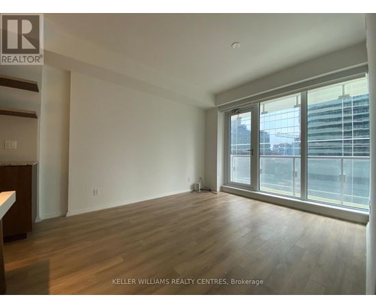 A spacious room with wooden floors and large windows at Keller Williams Realty Centres, Brokerage.