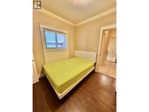 A bedroom with a bed and a window.