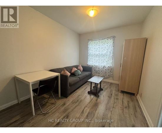 A living room with a couch, chair, and table.