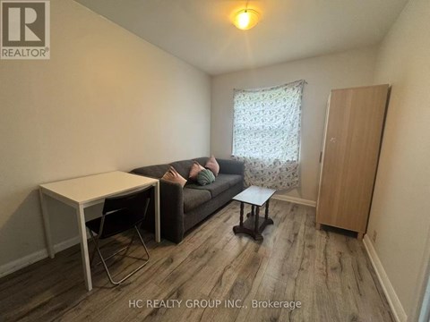 A living room with a couch, chair, and table.