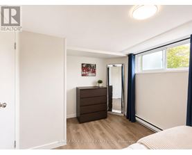 A bedroom with a dresser and a mirror.