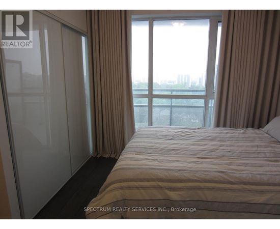A bedroom with a large bed and a view of the city.