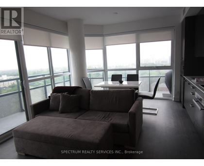 A living room with a brown couch and a television.