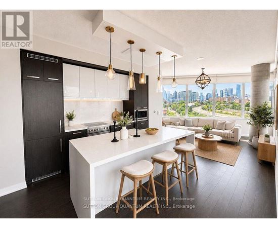 A modern kitchen with a large island and bar stools.
