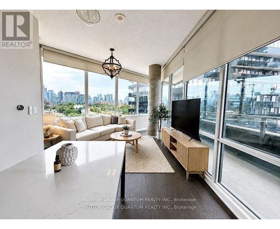 A living room with a television and a view of the city.
