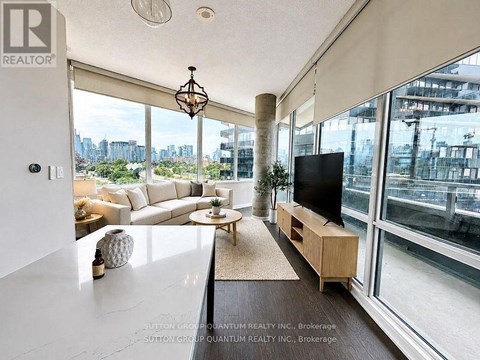 A living room with a television and a view of the city.