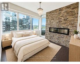 A bedroom with a stone wall and a large bed.
