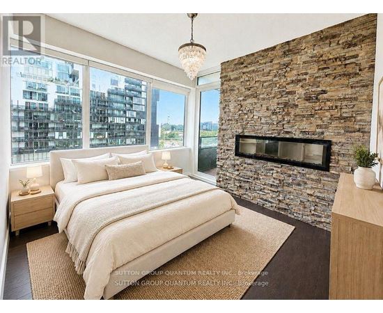 A bedroom with a stone wall and a large bed.
