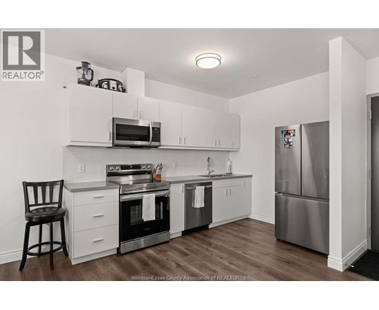 A kitchen with white cabinets and stainless steel appliances.