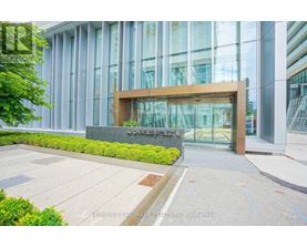 The front of a building with glass windows and a wooden entrance.