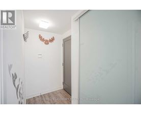 A room with a white wall and a brown decoration on it.