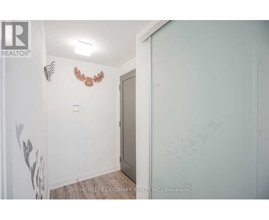 A room with a white wall and a brown decoration on it.