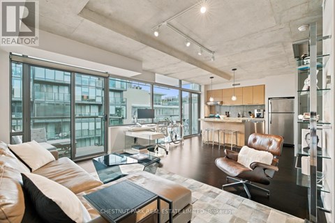 A modern living room with a brown leather couch and a glass table.